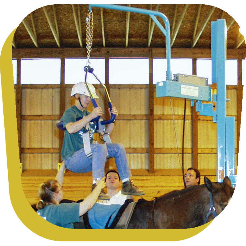 A disabled teen uses a Lifelyfts Post Mounted Equestrian Seat Lift to mount a horse.